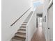 Modern staircase with wooden handrail, leading to a bright and open living space at 1317 Garner Rd # 101, Raleigh, NC 27610
