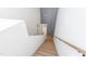 Bright staircase with natural wood treads leads to the upper level of the home at 1317 Garner Rd # 101, Raleigh, NC 27610