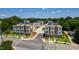 Aerial view capturing modern townhomes in an orderly street layout with lush greenery and solar panels at 1317 Garner Rd # 101, Raleigh, NC 27610