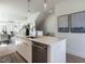 Modern kitchen island features stainless steel dishwasher, quartz countertop, modern pendant lighting, and open floorplan at 1408 Sawyer Rd # 101, Raleigh, NC 27610