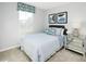 Cozy bedroom with natural light, stylish furnishings, and comfortable striped bedding at 156 Sunny Acres Rd, Garner, NC 27603