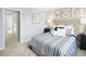 Comfortable bedroom features a queen bed with stylish blue striped comforter and a soft neutral color scheme at 156 Sunny Acres Rd, Garner, NC 27603