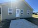 Exterior of home featuring a patio, multiple windows, and a back door at 163 Grace Pond Ave, Benson, NC 27504
