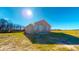 Rear view of a modern home on a spacious lot with a view to the green space behind at 163 Grace Pond Ave, Benson, NC 27504
