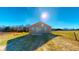 Back view of a modern home with a spacious yard and expansive green space at 163 Grace Pond Ave, Benson, NC 27504