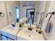 Bathroom with double sink vanity, framed mirrors, and modern fixtures at 163 Grace Pond Ave, Benson, NC 27504