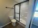 Bathroom features a new toilet, large shower with a glass enclosure and view to the outside at 163 Grace Pond Ave, Benson, NC 27504