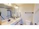 Bathroom with double sink vanity, framed mirrors, and modern fixtures at 163 Grace Pond Ave, Benson, NC 27504