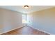 Cozy bedroom with wood-look flooring and a window, next to the walk-in closet at 163 Grace Pond Ave, Benson, NC 27504