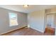 Bright bedroom featuring wood-look floors and a sunlit window, creating a welcoming space at 163 Grace Pond Ave, Benson, NC 27504
