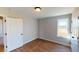 Bright bedroom with hardwood floors and two doors, offering an abundance of light at 163 Grace Pond Ave, Benson, NC 27504