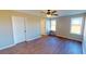 Spacious bedroom with hardwood flooring, ceiling fan, and natural light from large windows at 163 Grace Pond Ave, Benson, NC 27504