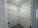 Walk-in closet featuring plenty of storage space with installed shelving and neutral walls at 163 Grace Pond Ave, Benson, NC 27504