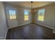 Bright dining area featuring hard surface floors, natural light, and a modern chandelier fixture at 163 Grace Pond Ave, Benson, NC 27504