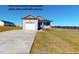 Charming single-story home featuring a two-car garage, stone accents, and a landscaped lawn at 163 Grace Pond Ave, Benson, NC 27504