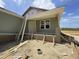 New construction exterior featuring a green siding and front porch at 163 Grace Pond Ave, Benson, NC 27504