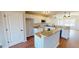 Stylish kitchen with white cabinets, granite counters, stainless appliances, and island at 163 Grace Pond Ave, Benson, NC 27504