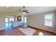 Open concept living room flowing into kitchen, bathed in natural light from large windows at 163 Grace Pond Ave, Benson, NC 27504