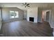 Bright living room featuring hard surface floors, a modern fireplace feature wall, and views through large windows at 163 Grace Pond Ave, Benson, NC 27504