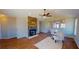 Bright living room features a stone fireplace and an open layout leading to the kitchen at 163 Grace Pond Ave, Benson, NC 27504