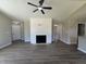 Inviting living room with hard surface floors, a modern fireplace feature wall, and neutral paint at 163 Grace Pond Ave, Benson, NC 27504