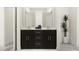 Modern bathroom featuring double vanity with dark wood cabinetry and sleek hardware, complemented by a white countertop at 1717 Goldfinch Perch Ln, Knightdale, NC 27545