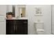 Modern bathroom featuring a dark vanity and a toilet, with light walls and decor at 1717 Goldfinch Perch Ln, Knightdale, NC 27545