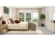 Bright bedroom featuring a luxurious bed with accent pillows, natural light, and tasteful decor at 1717 Goldfinch Perch Ln, Knightdale, NC 27545