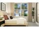 Stylish bedroom featuring a large window and a plush bed with decorative pillows at 1717 Goldfinch Perch Ln, Knightdale, NC 27545