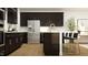 Modern kitchen featuring dark cabinets, a white island, and stainless steel appliances at 1717 Goldfinch Perch Ln, Knightdale, NC 27545
