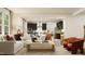Bright, open-concept living space with modern furnishings, an L-shaped couch, and views of the kitchen at 1717 Goldfinch Perch Ln, Knightdale, NC 27545
