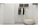 Walk-in closet with ample storage solutions and a comfortable ottoman for a luxurious dressing experience at 1717 Goldfinch Perch Ln, Knightdale, NC 27545
