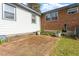 Back patio area with brick pavers and lush greenery at 1800 Tee Dee St, Raleigh, NC 27610