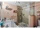Well-lit bathroom with a glass-enclosed shower, double vanity and tile floors at 1800 Tee Dee St, Raleigh, NC 27610