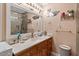 Well-lit bathroom with a vanity, large mirror, and swan decor at 1800 Tee Dee St, Raleigh, NC 27610