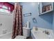 Traditional bathroom offers a bathtub, vanity, and blue walls at 1800 Tee Dee St, Raleigh, NC 27610