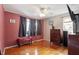 The bedroom offers wood floors, ceiling fan, and bright natural light at 1800 Tee Dee St, Raleigh, NC 27610