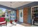 A cozy front porch with outdoor seating, brick accents, and a decorative front door at 1800 Tee Dee St, Raleigh, NC 27610