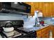 Close up of a well-equipped kitchen showcasing modern appliances and wood cabinets at 1800 Tee Dee St, Raleigh, NC 27610