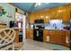 Efficient kitchen with wood cabinets and contrasting dark appliances at 1800 Tee Dee St, Raleigh, NC 27610