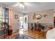 Inviting living room with hardwood floors, decorative wallpaper, and a view of the front door at 1800 Tee Dee St, Raleigh, NC 27610