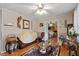 The carpeted living room boasts hardwood floors, decorative wallpaper, and a doorway to the main bedroom at 1800 Tee Dee St, Raleigh, NC 27610