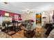 Open-concept living room featuring a fireplace, ceiling fan, and hardwood floors at 1800 Tee Dee St, Raleigh, NC 27610
