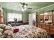 Spacious carpeted bedroom with a ceiling fan, window and access to the bathroom at 1800 Tee Dee St, Raleigh, NC 27610