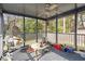 Relaxing screened porch with comfortable seating and a ceiling fan at 1800 Tee Dee St, Raleigh, NC 27610