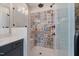 Shower with decorative tiling and glass enclosure, adjacent to a vanity at 1905 Cedar Dam Ln, Wendell, NC 27591