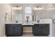 Well-lit bathroom featuring double vanity and a walk-in shower with glass door at 1905 Cedar Dam Ln, Wendell, NC 27591