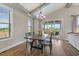 Dining room with hardwood floors, vaulted ceiling, and sliding door to patio at 1905 Cedar Dam Ln, Wendell, NC 27591