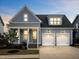 Charming blue two-story home with a two-car garage, landscaped front yard, and inviting entryway at 1905 Cedar Dam Ln, Wendell, NC 27591