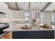 Bright kitchen with white cabinets, quartz countertops, stainless steel appliances, and large center island at 1905 Cedar Dam Ln, Wendell, NC 27591